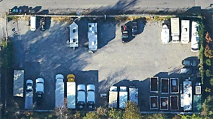 Fenced outdoor storage lot in South Park with parked vehicles